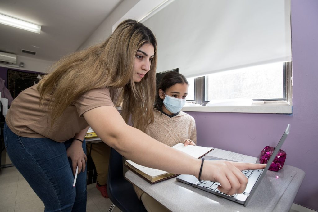 Student receiving help from teacher