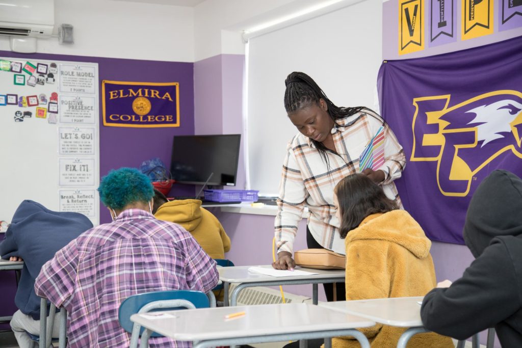 Teacher helping students