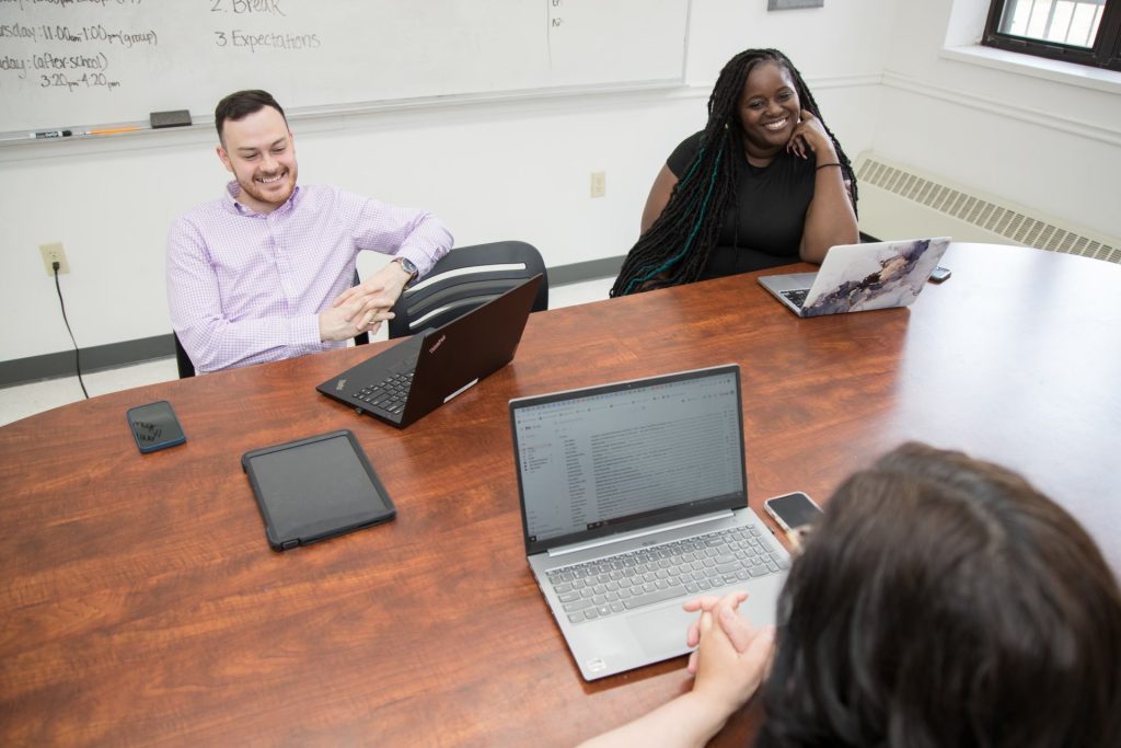 Teachers working at large wooden desk